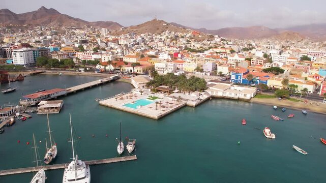 CAPE VERDE - 9.4.2025 - Fantastic aerial footage passing over a swimming pool on a port and headed into the city of Mindelo, Cape Verde.