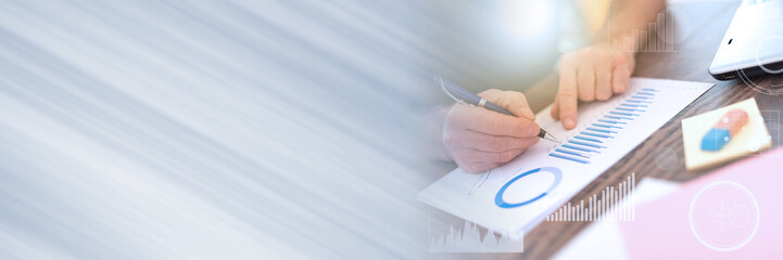 Man working on financial graphs, double exposure, light effect; panoramic banner