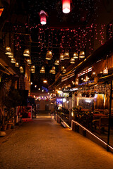 Night photo of a colorful street with many glowing lights and restaurants in the central part of Istanbul, Turkey