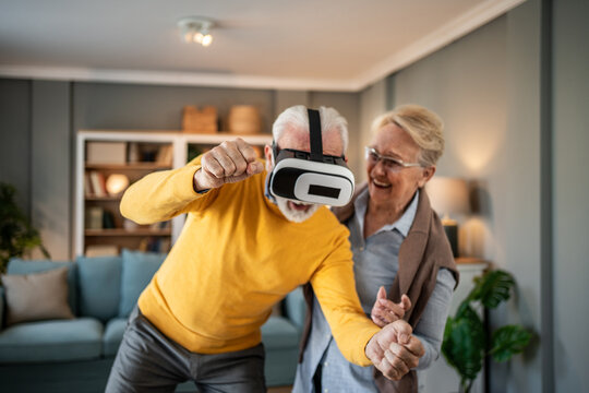 Senior couple having fun playing virtual reality game