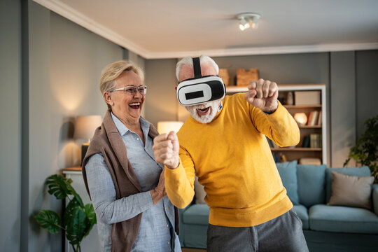 Senior couple enjoying virtual reality game at home