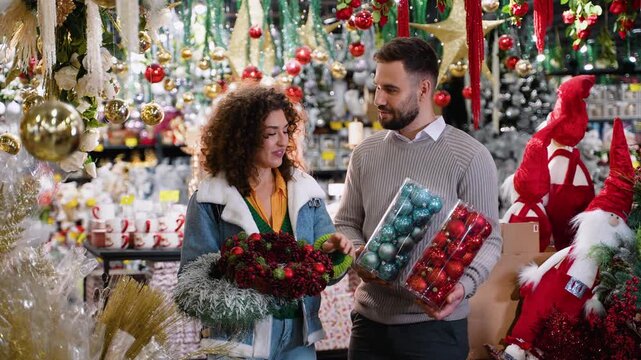 Happy couple shopping for Christmas decorations