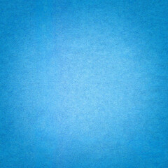 Blue paper background texture with gradient. Vintage cerulean cardboard backdrop with dark vignette border.
