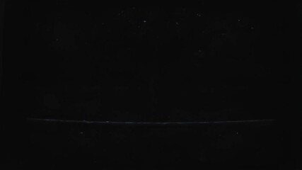 A mesmerizing mix of digital noise and static takes over the screen as an old television struggles to maintain a picture. Flickering lights create a surreal atmosphere in the dark room. - Powered by Adobe