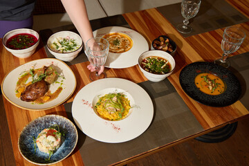 An Artistic Food Display Artfully Arranged on a Beautiful Wooden Table with Elegant Glassware