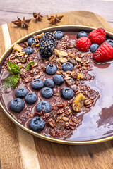 The cool color palette of the blueberries and wood is warmed by the golden and toasty tones of the cereal flakes