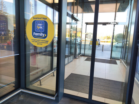Gualdo Tadino, Italy - November 04, 2025: Entrance of Eurospin supermarket showcasing modern glass doors and promotional Family+ app advertisement, inviting customers to explore exclusive offers