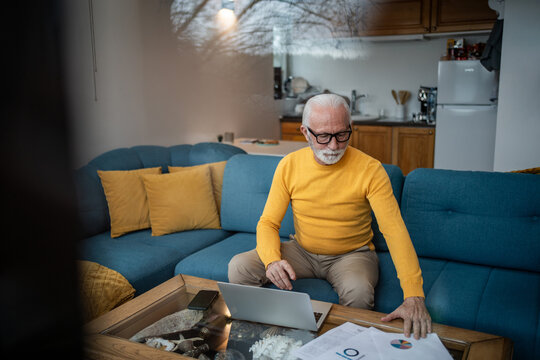 Senior man working from home managing finances