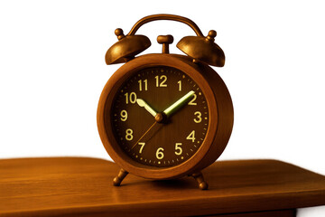 Bronze retro style alarm clock with illuminated hands and numbers on a wooden surface, symbolizing waking up and deadlines