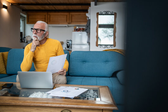 Senior man working from home contemplating financial planning