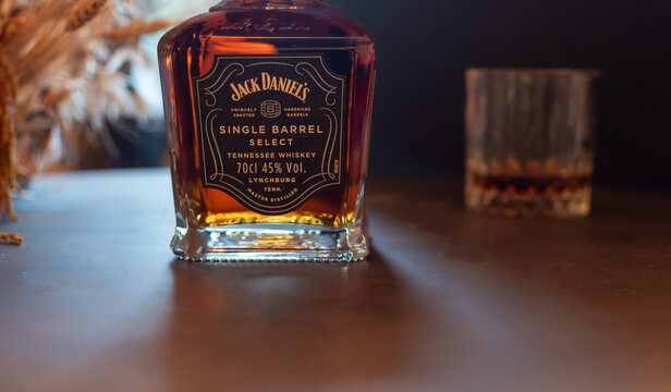 Bottle of Jack Daniel's Single Barrel Select Tennessee Whiskey bottle with blurred dram glass. Dramatically lit product shot with ample copy space on right. Ukraine, Zhytomyr, November 4, 2025