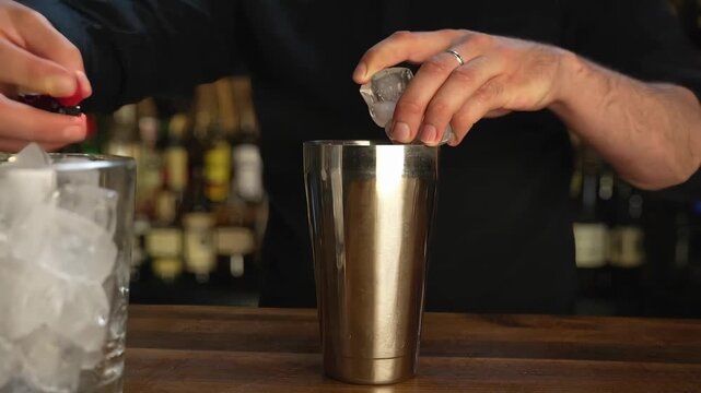 Crafting a refreshing cocktail with ice and a shaker at a bar in the evening