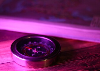 close up of a compass and atlas maps travel navigation
