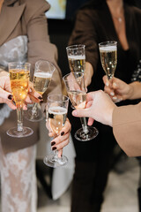 Group of people toasting with champagne glasses at festive celebration or corporate event