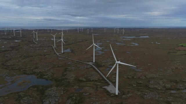 Large wind towers generate clean power in wide rural landscape