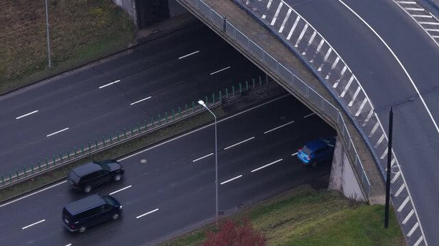 Top-down view of a multilane road and overpass in Vilnius, Lithuania, showing vehicles, traffic markings, and urban infrastructure.