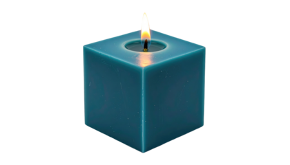 Square teal candle with lit flame on black background casting a warm glow in hollowed top