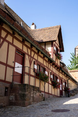 Obraz premium Majestic Kaiserburg Nürnberg in Germany, featuring 11th-century castles, royal palace, gardens, Sinwellturm tower, and panoramic city views, perfect for travel and history content.