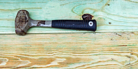 Sledge hammer on wood background