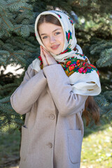 Portrait of a young beautiful woman with a scarf on her head