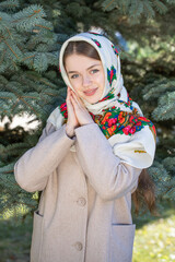 Portrait of a young beautiful woman with a scarf on her head