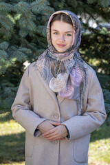 Portrait of a young beautiful woman with a scarf on her head
