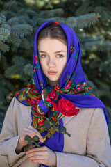 Portrait of a young beautiful woman with a scarf on her head