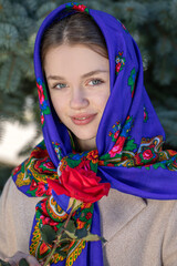Portrait of a young beautiful woman with a scarf on her head