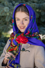 Portrait of a young beautiful woman with a scarf on her head