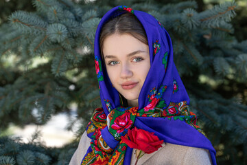 Portrait of a young beautiful woman with a scarf on her head
