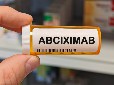 orange plastic Box of ABCIXIMAB tablets on a hospital pharmacy table used to prevent blood clots an antiplatelet antibody. PHARMACY warehouse