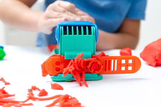 Child playing,molding plasticine.Kid sculpts with clay stucco.Play dough.art creativity,craft at kindergarten.Development of fine motor skills.sensory education at home - Powered by Adobe