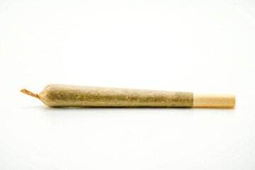 A joint after rolling, with a paper filter at left marijuana cigarette. Joint rolled cannabis cigarette, Prerolled Stick real photo white background