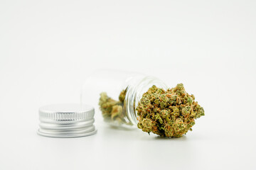 Cannabis flower buds, cannabis bud closeup of medical fresh marijuana flowers. Weed buds, Cannabis stem Medical marijuana bud in the packaging glass container photo on a white background