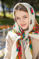 Portrait of a young beautiful woman with a scarf on her head