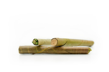 blunt cigar that has nature leaf and filled with cannabis. blunt marijuana tobacco leaf joint, marijuana blunt cigar, cannabis blunt cigarette prerolled Stick real photo white background