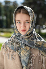 Portrait of a young beautiful woman with a scarf on her head