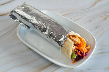 Delicious Rolo Durum kebab portable meal, Warm chicken wrap with slaw, Streetstyle chicken roll with crunchy vegetables, Foilwrapped seasoned chicken with crisp slaw in tortilla