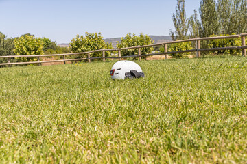 A white helmet on the green grass background