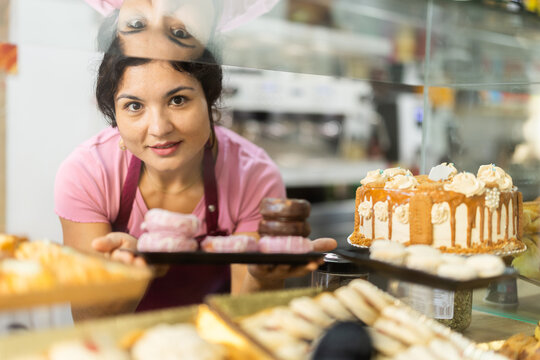 Bakery latino saleswoman offers to buy fresh sweet cakes