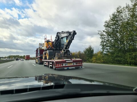 Kiel, Germany - 05. November 2025: Volvo excavator being transported by lowboy truck on highway