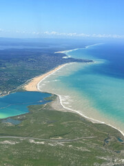 Aerial view of Istanbuls vibrant coastline with clear waters and sandy beaches under a bright sky.