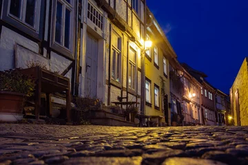 Fototapeten Enge Straßen Narrow streets with medieval houses in Quedlinburg, Germany  © golovianko