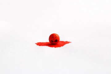 Sphere falls in fright into a drop of red ink