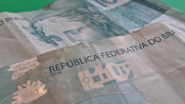 One hundred real notes on a green background