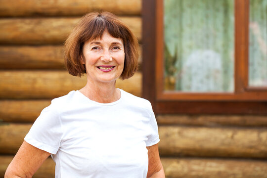  Portrait old woman on wooden wall background