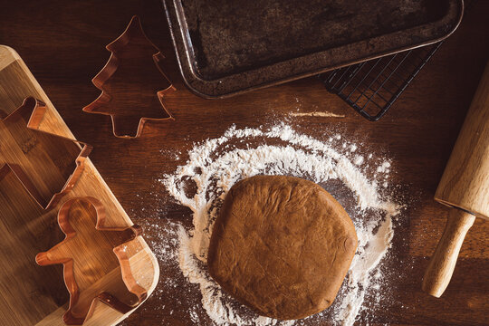 Gignerbread dough on flour with rolling pin and cookie cutters