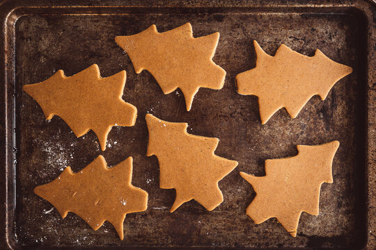 gingerbread cookie trees cut out on cookie sheet