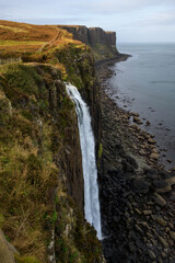 Waterfall at Ellishadder on the Isle of Skye flowing off a cliff into the Atlantic Ocean, Scottish Highlands, Scotland, UK, Europe
