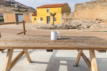 White electric kettle on the gray wooden table background